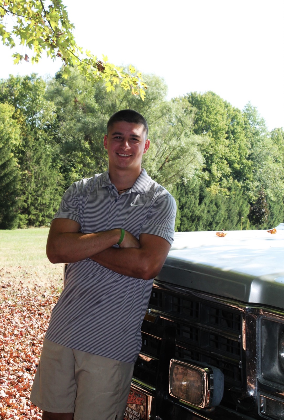 Dylan Tippmann, owner of TMT Enterprises, leaning against a truck